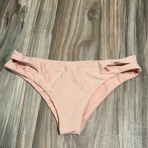 Soft pink bikini bottoms with open fabric design on hips